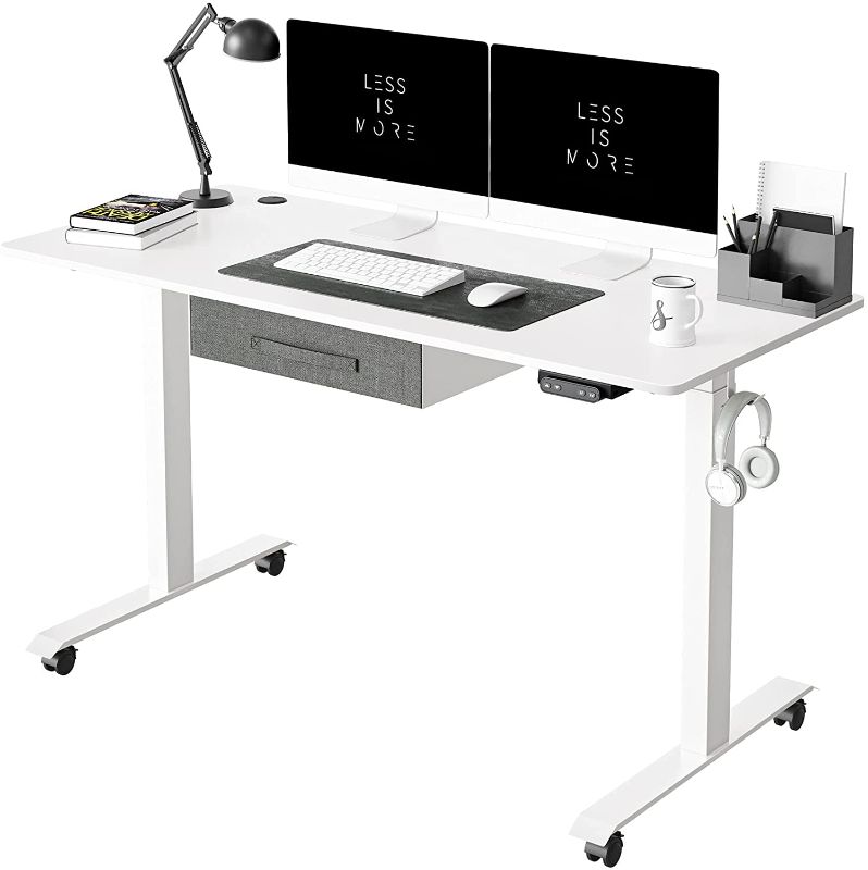 Photo 1 of FEZIBO Standing Desk with Drawer, Adjustable Height Electric Stand up Desk, 55 x 24 Inches Sit Stand Home Office Desk, Ergonomic Workstation White Steel Frame/White Tabletop
