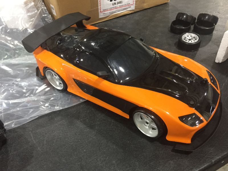 Photo 2 of Jada Toys Fast & Furious Han’s Mazda RX-7 Drift RC Car, 1: 10 Scale 2.4Ghz Remote Control Orange & Black, Ready to Run, USB Charging (Standard) (99700)
