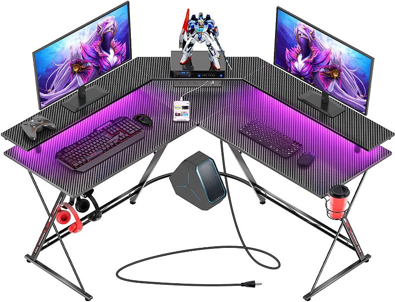 Photo 1 of Seven Warrior Gaming Desk 50.4” with LED Strip & Power Outlets, L-Shaped Computer Corner Desk Carbon Fiber Surface with Monitor Stand, Ergonomic Gamer Table with Cup Holder, Headphone Hook, Black