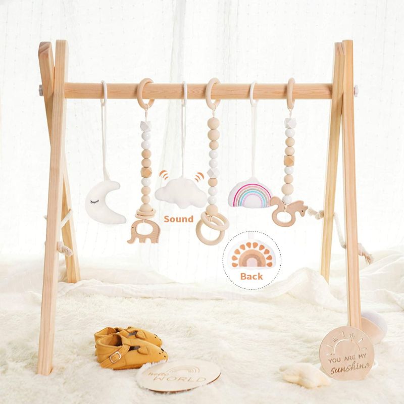 Photo 1 of little dove Baby Play Gym Wooden Baby Gym with 6 Toys Foldable Play Gym Frame Activity Gym Hanging Bar Baby Toy White
