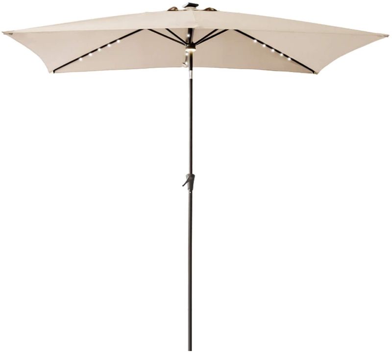 Photo 1 of FLAME&SHADE 6.5 x 10 ft Circle Solar Powered Outdoor Market Patio Table Umbrella with LED Lights and Tilt, Beige
