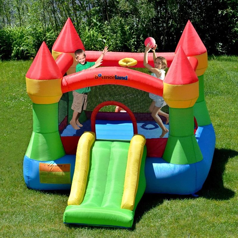 Photo 1 of Bounceland Bounce House Castle with Basketball Hoop Inflatable Bouncer, Fun Slide, Safe Entrance Opening, UL Certified Strong Blower Included, 12 ft x 9 ft x 7 ft H, Kid Castle Party Theme Bounce House
