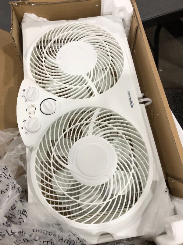 Photo 2 of Amazon Basics Window Fan with Manual Controls, Twin 9-Inch Reversible Airflow Blades
