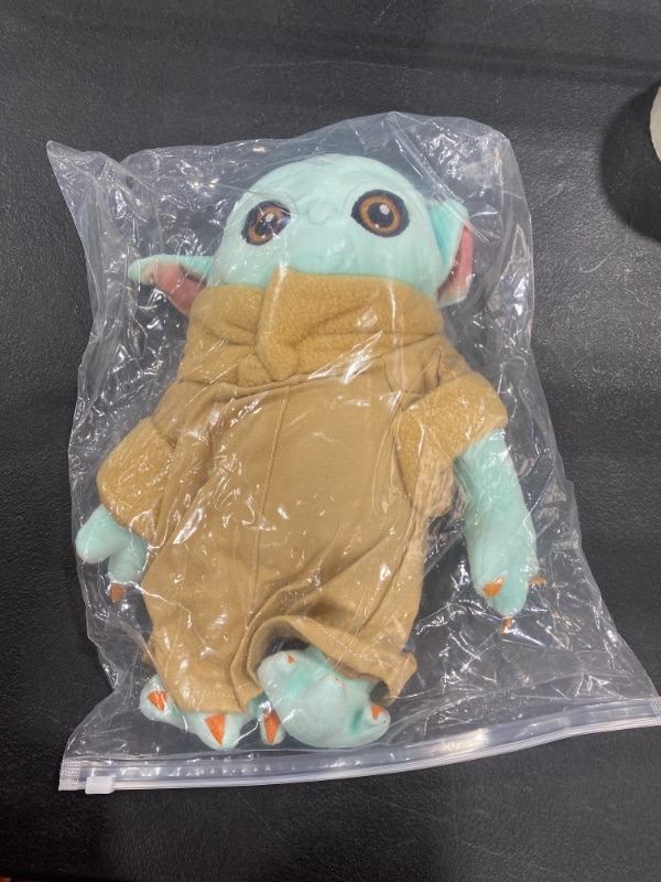 Photo 1 of baby yoda plushie, mandalorian