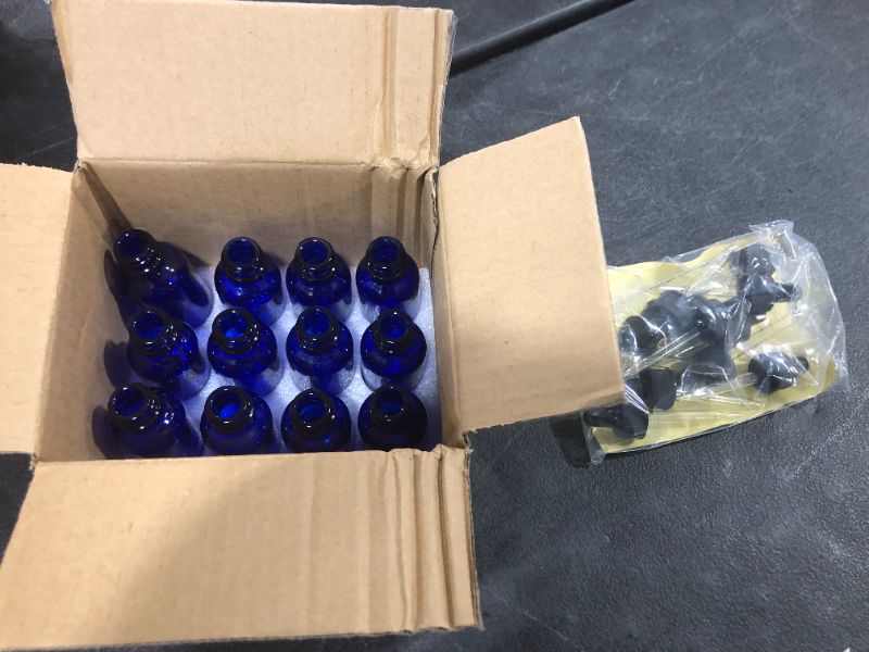 Photo 2 of 12 Pack 30 ml 1 oz Blue Glass Bottles with Glass Droppers and Black cap.Glass Dropper Bottles for Essential Oils,Lab Chemicals,Colognes,Perfumes.Included 1 Brush,2 Funnels and 24 Labels.
