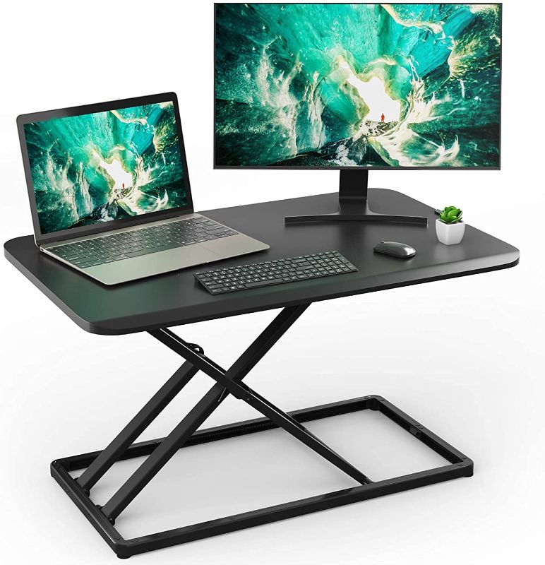 Photo 1 of Standing Desk Converter Height Adjustable Stand up Desktop Riser, Sit to Stand Gas Spring Workstation 28.5 inches for Laptop & Monitors for Home Office by HUANUO
