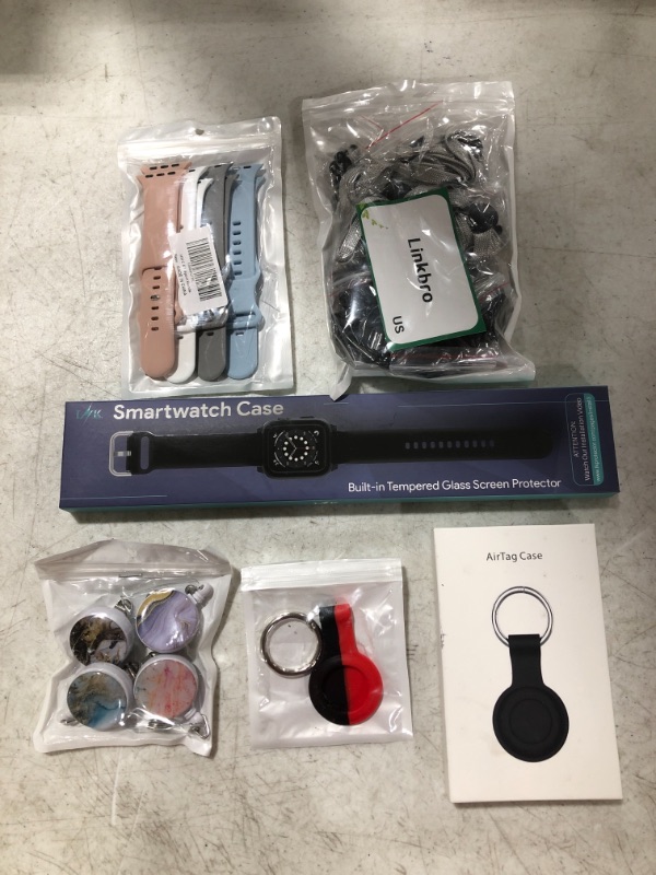 Photo 1 of VARIOUS SMART DEVICE ACCESSORIES, LOT OF 6 ITEMS. WATCH BANDS, LANYARDS, AIR TAG CASE....