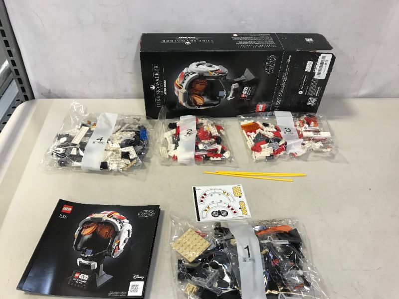 Photo 2 of LEGO Star Wars Luke Skywalker (Red Five) Helmet 75327 Fun, Creative Building Kit for Adults; Collectible, Brick-Built Star Wars Memorabilia for Display (675 Pieces) new, open for pictures, damages to packaging 

