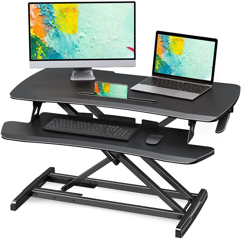 Photo 1 of WOKA Standing Desk Converter, 36" Height Adjustable Stand Up Desk Riser Fits Dual Monitor and Laptop, Sit Stand Desk Riser for Home Office, Standing Desk Riser with Ergonomic Keyboard Tray, Black
