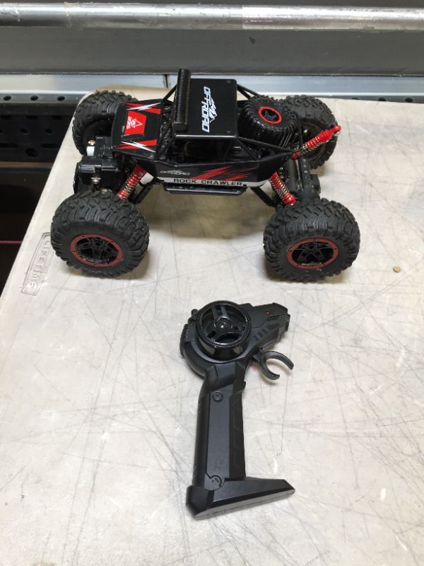 Photo 2 of TEMI RC Cars 1:14 Scale Remote Control Car, 4WD Dual Motors Rock Crawler, Speed 20 Km/h All Terrains Electric Toy Off Road RC Monster Truck with Two Rechargeable Batteries for Boys Kids and Adults---ITEM IS DIRTY---
