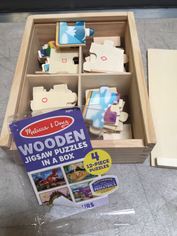 Photo 1 of Melissa & Doug Dinosaurs 4-in-1 Wooden Jigsaw Puzzles in a Storage Box (48 pcs)
