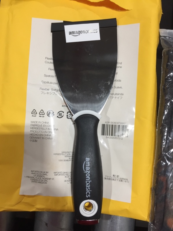 Photo 2 of Amazon Basics 3" Flexible, Soft Grip, Carbon Steel Putty Knife with Hammer End
