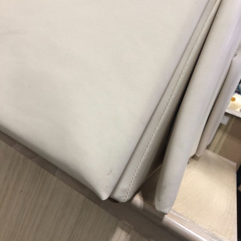 Photo 1 of CREME FAUX LEATHER OTTOMAN 17H X 15W INCHES
