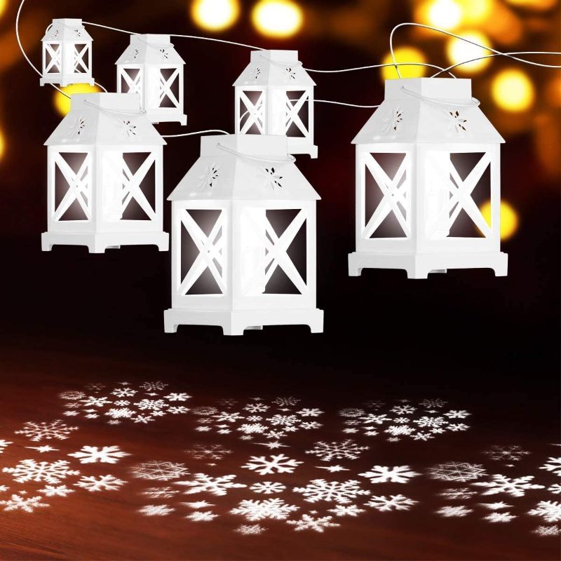 Photo 1 of  YUNLIGHTS Christmas String Lights - 22.6 Ft Snowflake Projector Lights with 6Pcs LED Lantern Projection- Plug in Hanging Lights for Indoor Outdoor Patio Porch Bedroom Party Christmas Decorations

