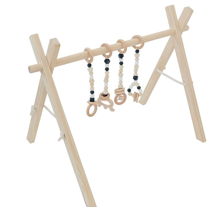 Photo 1 of Poppyseed Play Wooden Baby Play Gym, Foldable Frame w/Hanging Bar, Tied Cotton Cord & Wooden Bead Toys, Gender Neutral Baby Activity Set, Easy to Assemble (Natural Wood, Black Toys)
