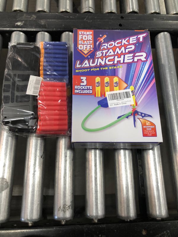 Photo 1 of BOX LOT- ROCKET LAUNCHER AND SOFT FOAM DARTS