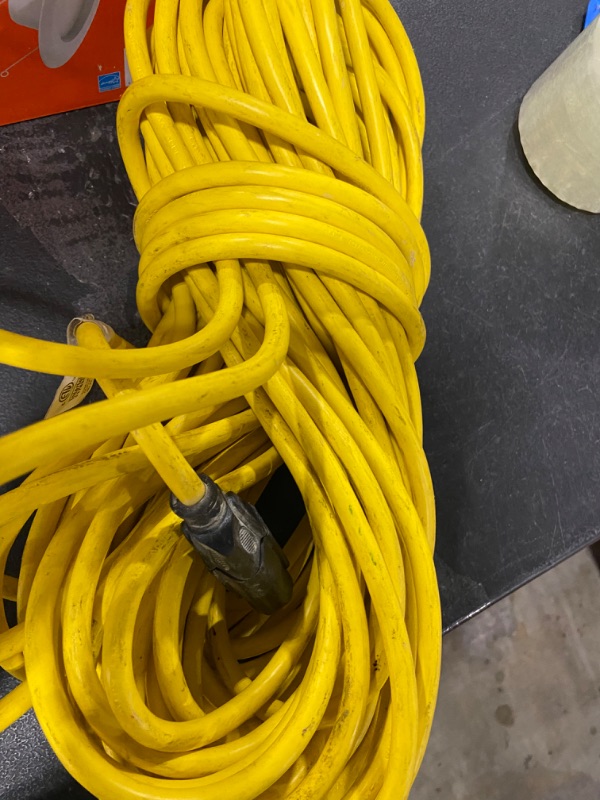 Photo 1 of Yellow One Plug Extension Cord (UNKNOWN LENGTH)