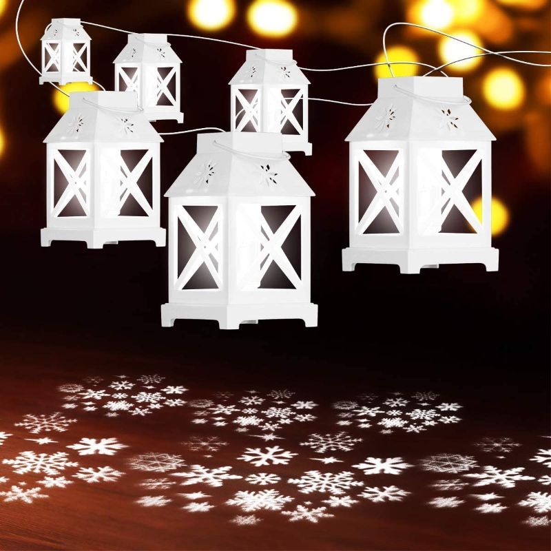 Photo 1 of YUNLIGHTS Christmas String Lights - 22.6 Ft Snowflake Projector Lights with 6Pcs LED Lantern Projection- Plug in Hanging Lights for Indoor Outdoor Patio Porch Bedroom Party Christmas Decorations
