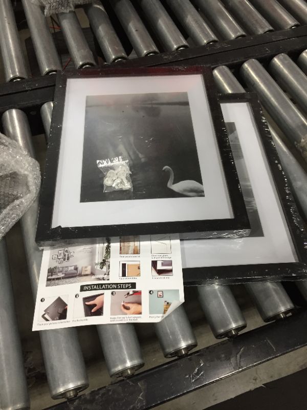 Photo 2 of **PACK OF TWO** 11x17 picture frames with white border, hardware included!!