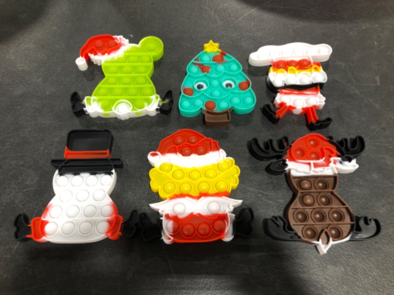 Photo 1 of CHRISTMAS HOLIDAY THEMED PUSH POP SILICONE RUBBER FIDGET SENSORY TOYS. PACKAGE OF 6 ITEMS.