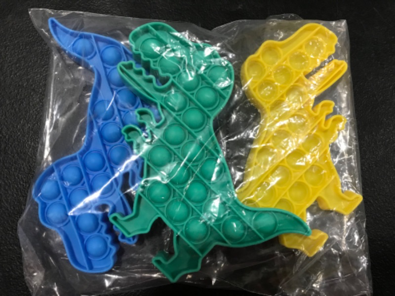 Photo 1 of 3 pack of T Rex Pop It toys- Blue, yellow, green