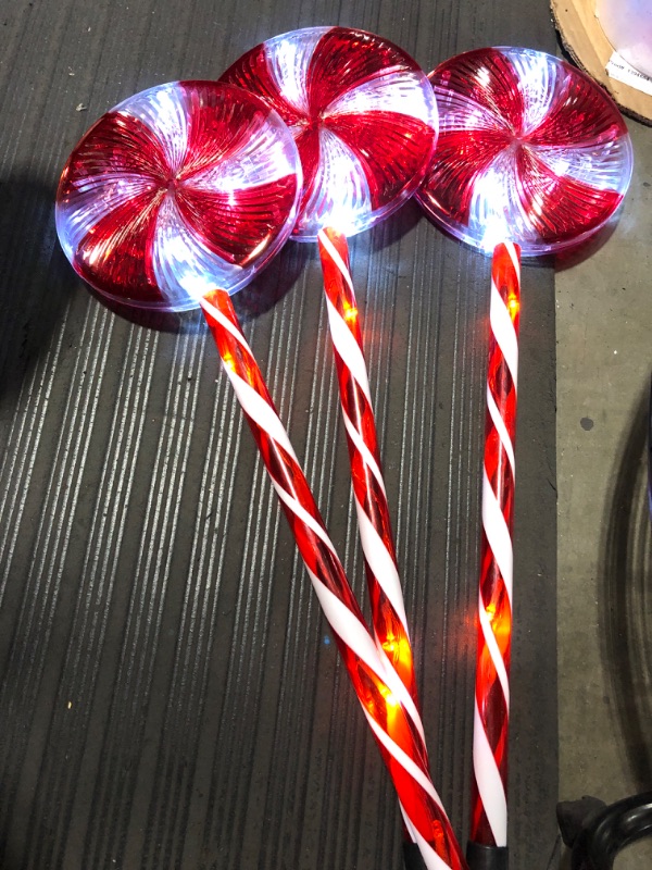 Photo 2 of Alpine Corporation 28" H Outdoor Candy Cane Yard Stakes with Red and White LED Lights (Set of 3)
