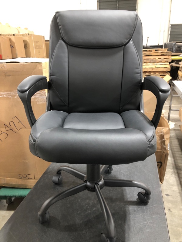 Photo 1 of FAUX LEATHER ROLLING OFFICE CHAIR. BLACK. PRIOR USE.