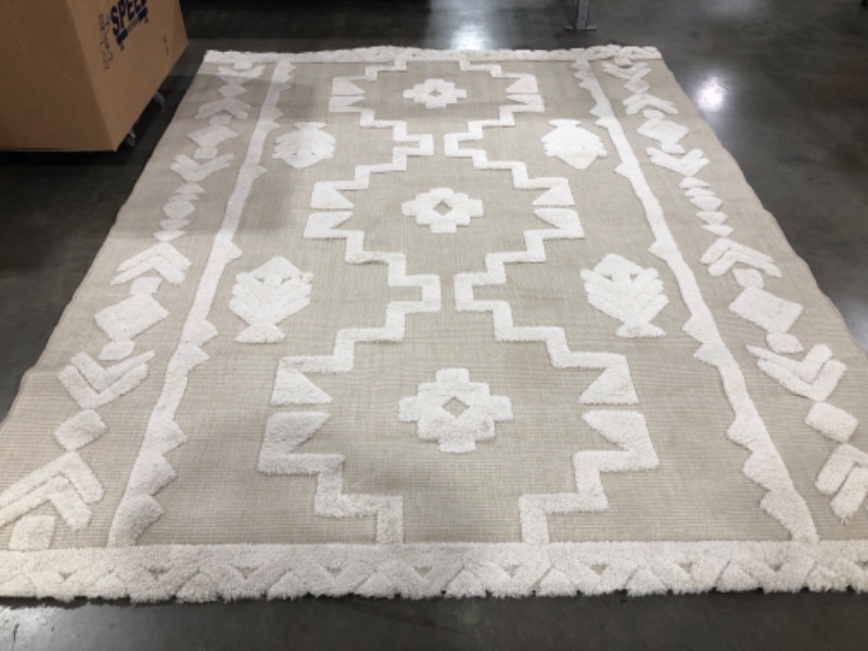 Photo 1 of 8' X 10' AZTEC STYLE AREA RUG. CREAM/LIGHT TAN COLORED. PRIOR USE. SOME STAINING & LIGHT FRAYING.