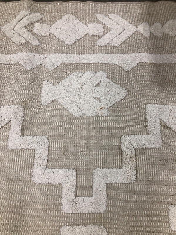 Photo 1 of 8' X 10' AZTEC STYLE AREA RUG. CREAM/LIGHT TAN COLORED. PRIOR USE. SOME STAINING & LIGHT FRAYING.
