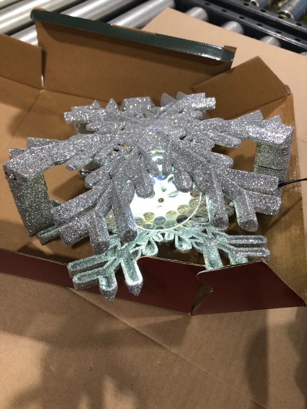 Photo 3 of Christmas Tree Topper Lighted with Built-in Led Rotating Snowflake Projector Lights, 9.6” Hollowed Tree Topper with Silver Spangles Plug In for Indoor Home Xmas New Year Party Holiday Night Tree Decor
