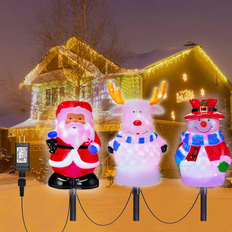 Photo 1 of Christmas Pathway Lights Outdoor with Rotating Light Cute 3D Shape 3 in 1 Santa Snow Reindeer Xmas Light Water Snowproof Christmas Garden Stakes Landscape Lights for Indoor, Outdoor, Yard, Walkway