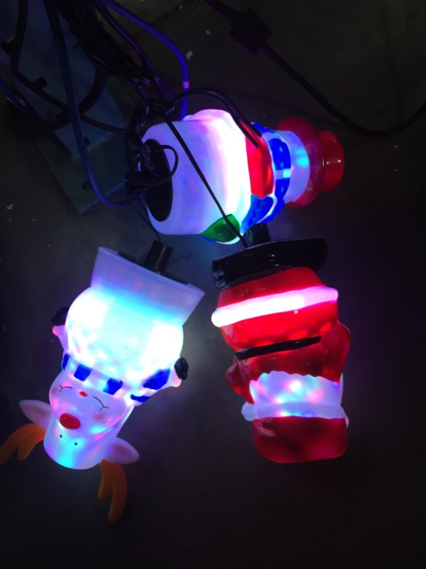 Photo 2 of Christmas Pathway Lights Outdoor with Rotating Light Cute 3D Shape 3 in 1 Santa Snow Reindeer Xmas Light Water Snowproof Christmas Garden Stakes Landscape Lights for Indoor, Outdoor, Yard, Walkway