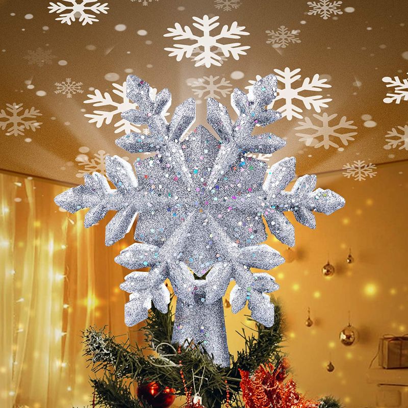 Photo 1 of Christmas Tree Topper Lighted with Built-in Led Rotating Snowflake Projector Lights, 9.6” Hollowed Tree Topper with Silver Spangles Plug In for Indoor Home Xmas New Year Party Holiday Night Tree Decor
