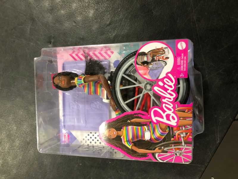 Photo 2 of Barbie Fashionistas Doll #166 with Wheelchair & Crimped Brunette Hair Wearing Rainbow-Striped Dress, White Sneakers, Sunglasses & Fanny Pack, Toy for Kids 3 to 8 Years Old
