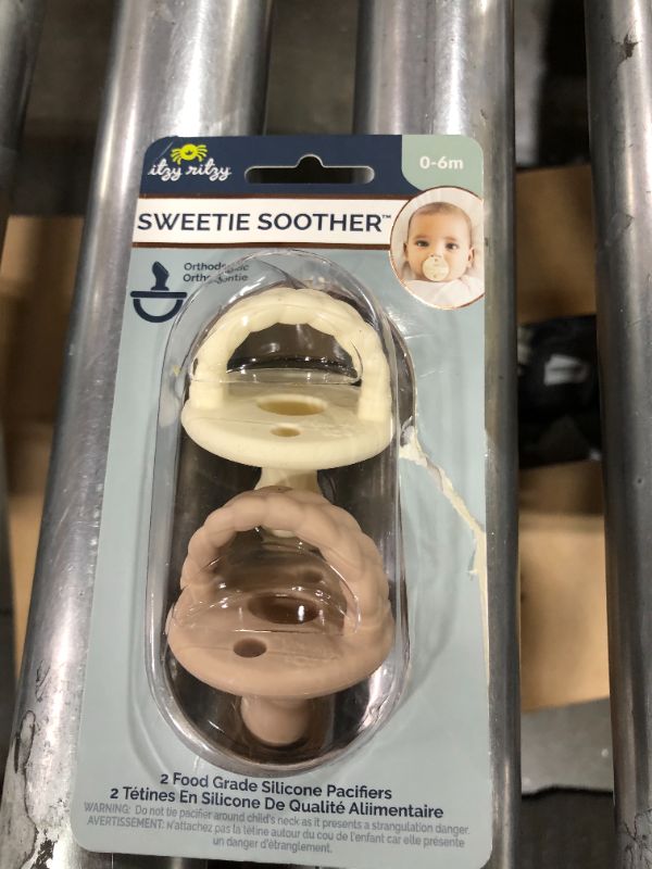 Photo 2 of Itzy Ritzy Sweetie Soother Pacifier Set of 2 - Silicone Newborn Pacifiers with Collapsible Handle & Two Air Holes for Added Safety; Set of 2 in Buttercream & Toast, Ages Newborn & Up
