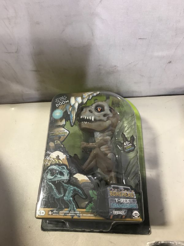 Photo 1 of WowWee Untamed Skeleton T-Rex by Fingerlings – Doom (Ash) – Interactive Collectible Dinosaur