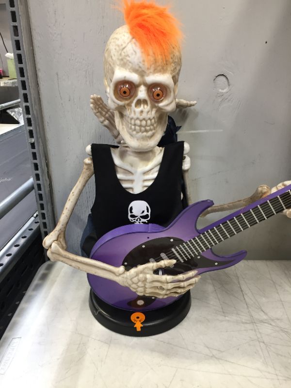 Photo 4 of 37inch Voice-Activated Skeleton Skull, Indoor/Outdoor Halloween Decoration,Sit on The Fireplace and Play The Guitar,Creepy Tabletop Decor (minor damage to arm)
