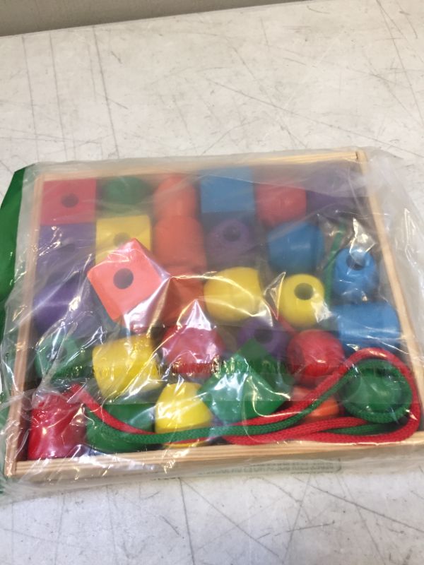 Photo 1 of Melissa & Doug Primary Lacing Beads - Educational Toy With 30 Wooden Beads and 2 Laces
