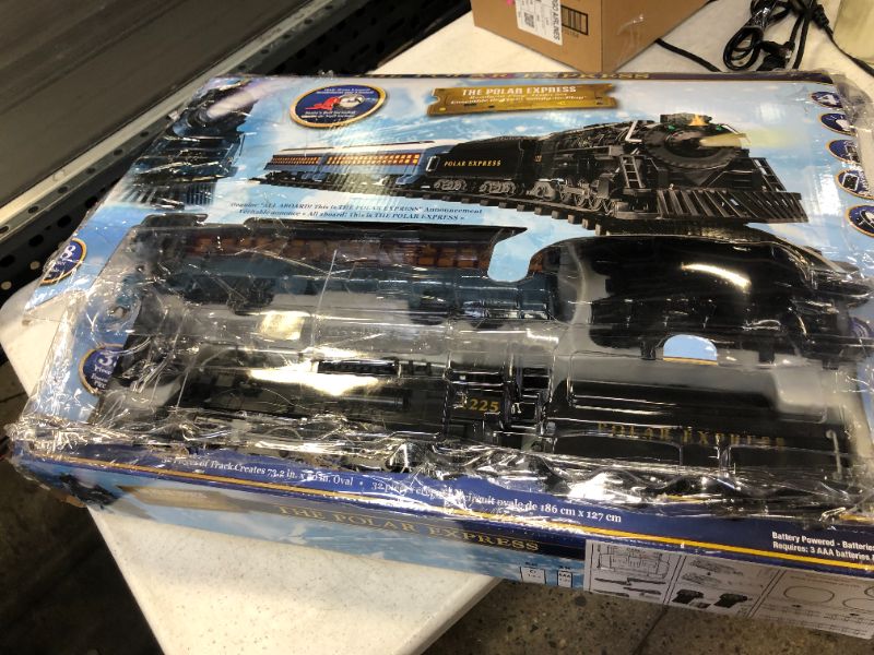 Photo 4 of Lionel The Polar Express battery-powered Train Set with Remote + 12-Piece Straight Track Expansion Pack
