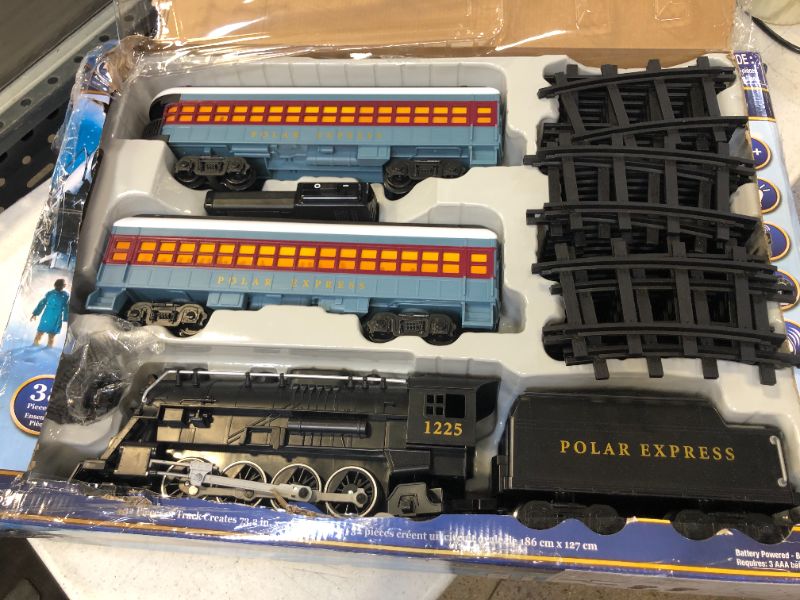 Photo 3 of Lionel The Polar Express battery-powered Train Set with Remote + 12-Piece Straight Track Expansion Pack
