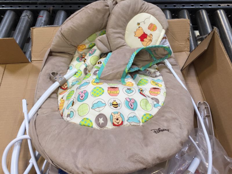 Photo 2 of Bright Starts Winnie the Pooh Dots & Hunny Pots Baby Bouncer with Vibrating Infant Seat, Music & 3 Playtime Toys, 23x19x23 Inch
