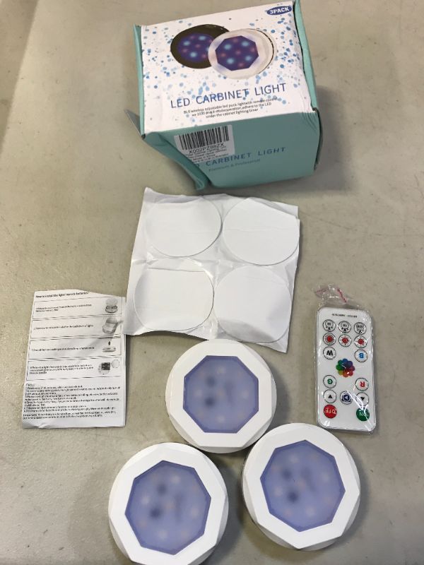 Photo 1 of Led Puck Lights with Remote Control, UYICOO Wireless Color Changing Dimmable Under Cabinet Lighting, 3500K Battery Operated Sticker Light with Timing, Under Counter Lights for Closet (White 3 Packs) DAMAGES TO PACKAGING 
