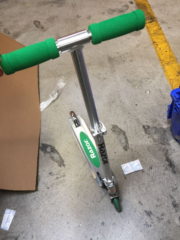 Photo 2 of green razor scooter - item is new ( wheels are dirty from being tested ) 