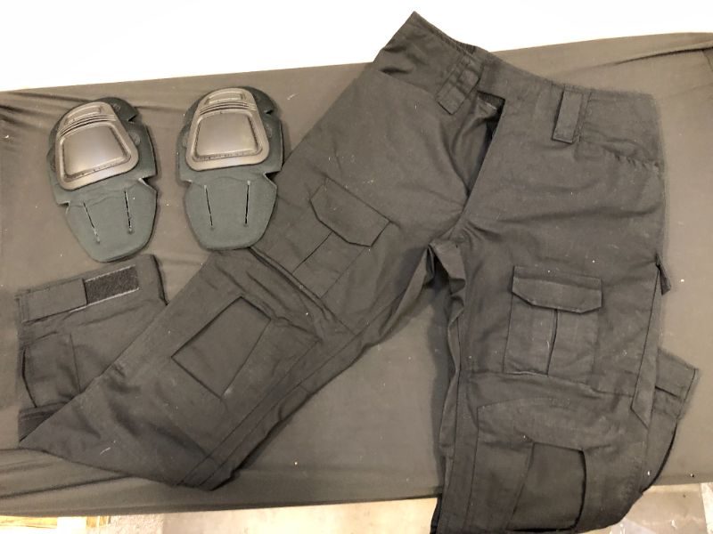 Photo 1 of BLACK TACTICAL PANTS SIZE 30 
WITH KNEE PADS