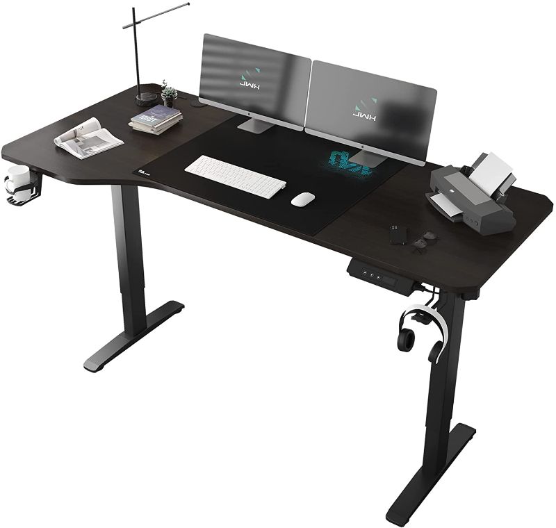 Photo 1 of Jwx L Shaped Electric Standing Desk, 63 inches Adjustable Height Computer Desk with Cup Holder, Headphone Hook, Cable Manager, and Mouse pad, Brown Panel
