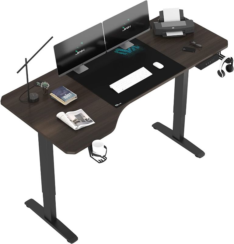 Photo 1 of Jwx L Shaped Electric Standing Desk, 63 inches Adjustable Height Computer Desk with Cup Holder, Headphone Hook, Cable Manager, and Mouse pad, Brown Panel
