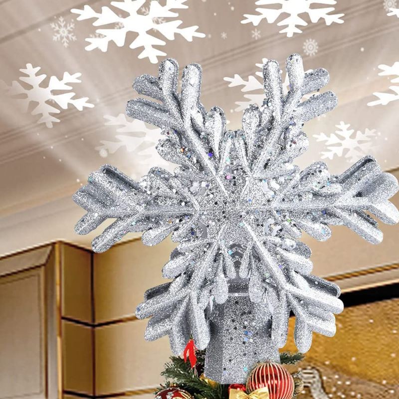 Photo 1 of EJIDOO Snowflake Christmas Tree Topper Decoration, Silver Snow Rotating Projection Lights, 3D Glitter Hollow Christmas Tree Decor for Indoor Xmas Tree Ornament/Holiday//Winter Home Party (Silver)