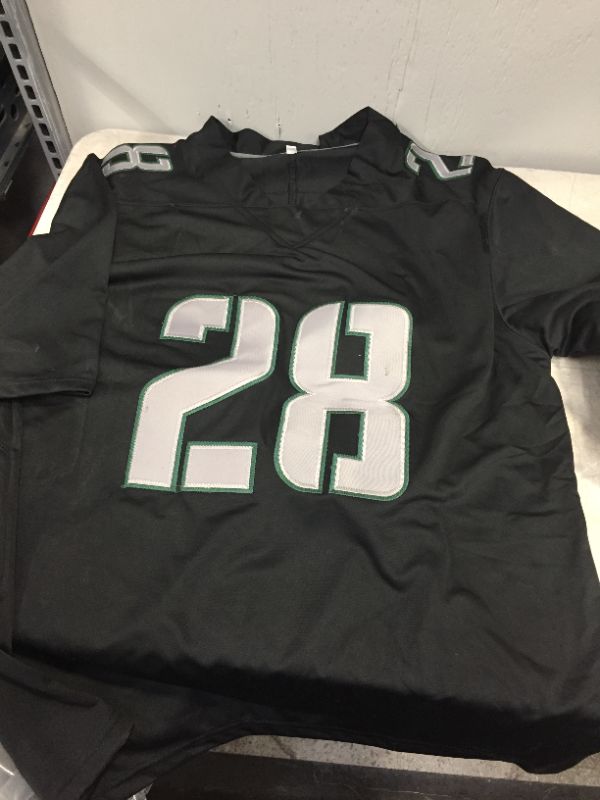 Photo 3 of GENERIC FOOTBALL JERSEY BLACK AND GREEN (DILLON NUMBER 28) MARKED AS SIZE LARGE -- SLIGHT DAMAGE TO NUMBER IN BACK 