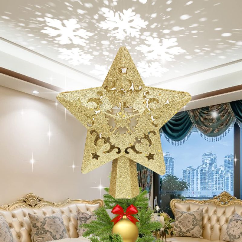 Photo 1 of Christmas Tree Topper, BLVRYVIO Christmas Tree Topper Lighted with Rotating Snowflake LED Projector, 3D Gold Star Tree Toppers Christmas Decorations for Xmas Indoor Use
