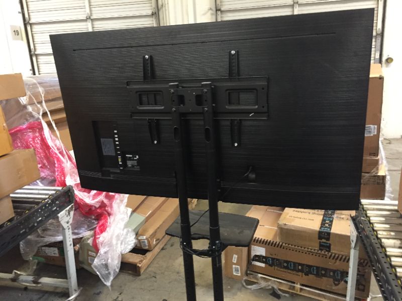 Photo 1 of Samsung Professional HG65NJ690UFXZA 65" SMART UHD Hospitality TV ON ROLLERS. INCLUDES ONLY POWER CABLE, TV AND ROLLING CART. FUNCTIONS FINE JUST VERY DIRTY/DUSTY